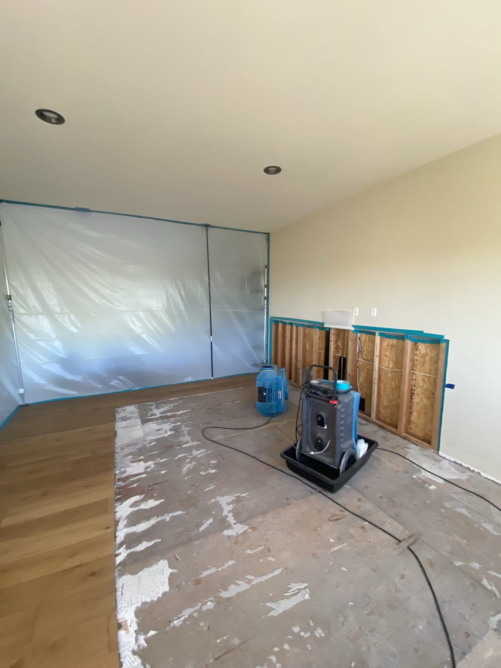 Home Doctors Restoration crew mitigating water damage — containment, structural drying, and demo in progress