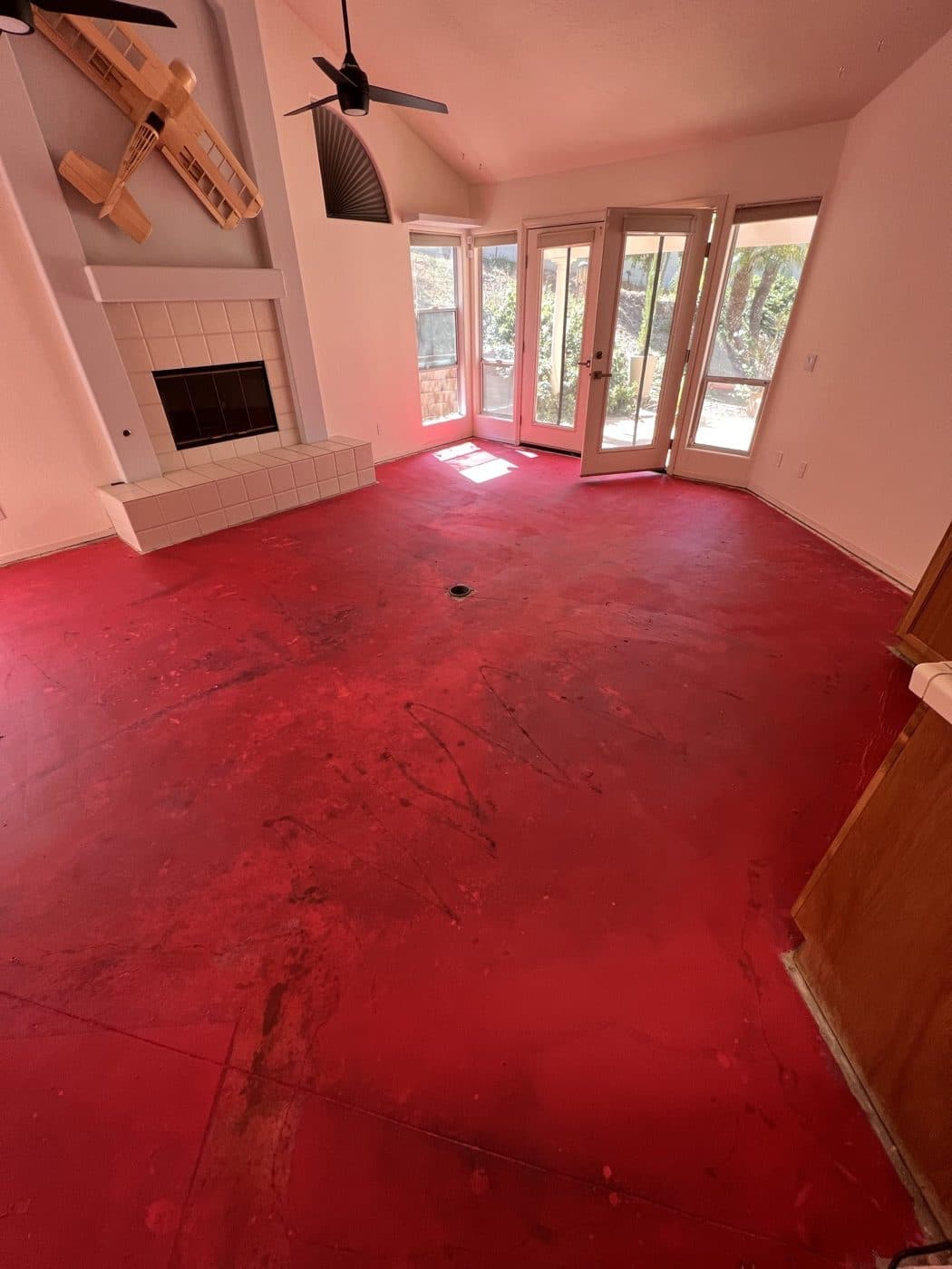 Living room subfloor exposed after flood cleanup, flooring removed down to the slab