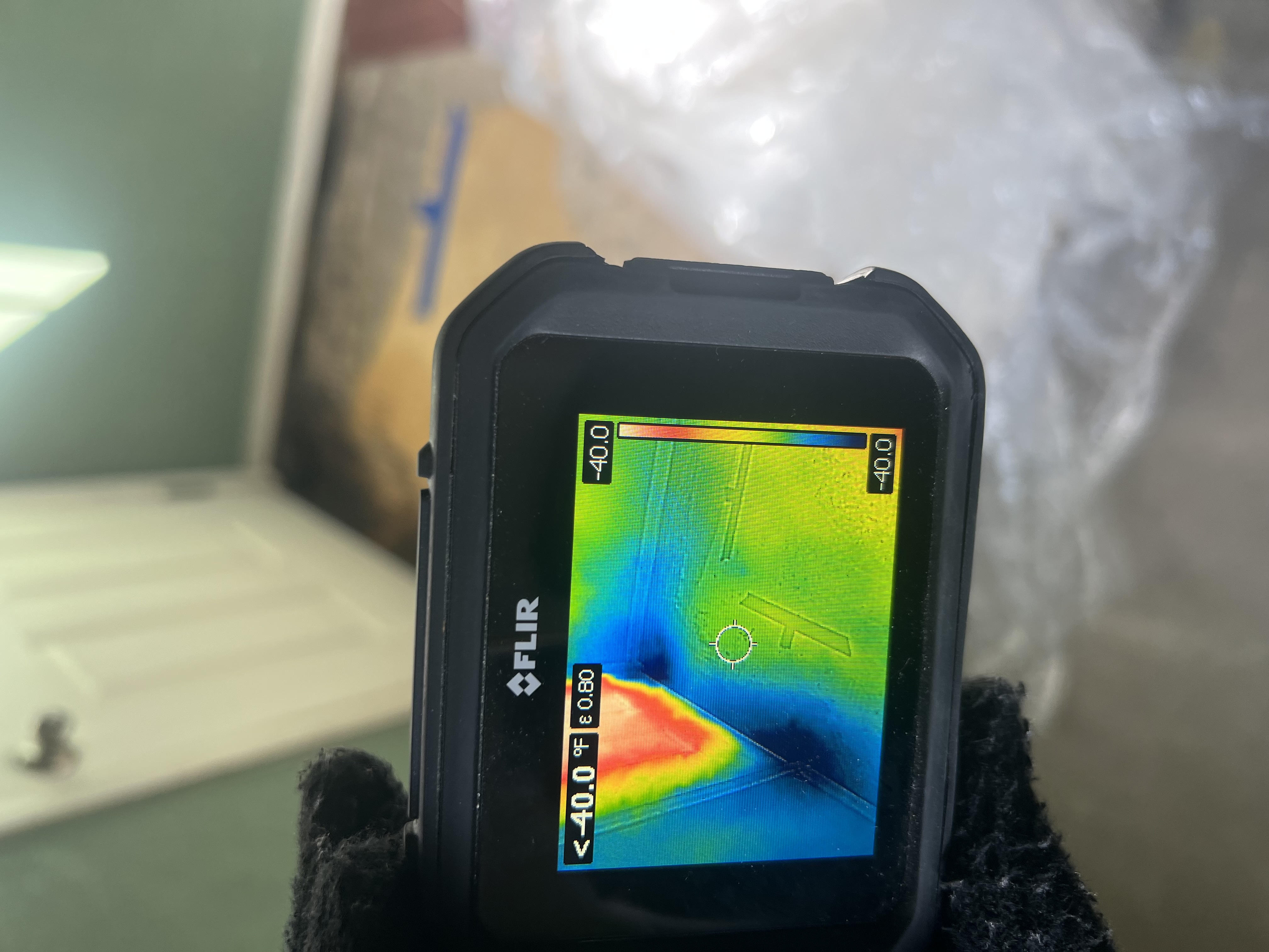 Thermal imaging camera reading during a moisture inspection in a home under restoration