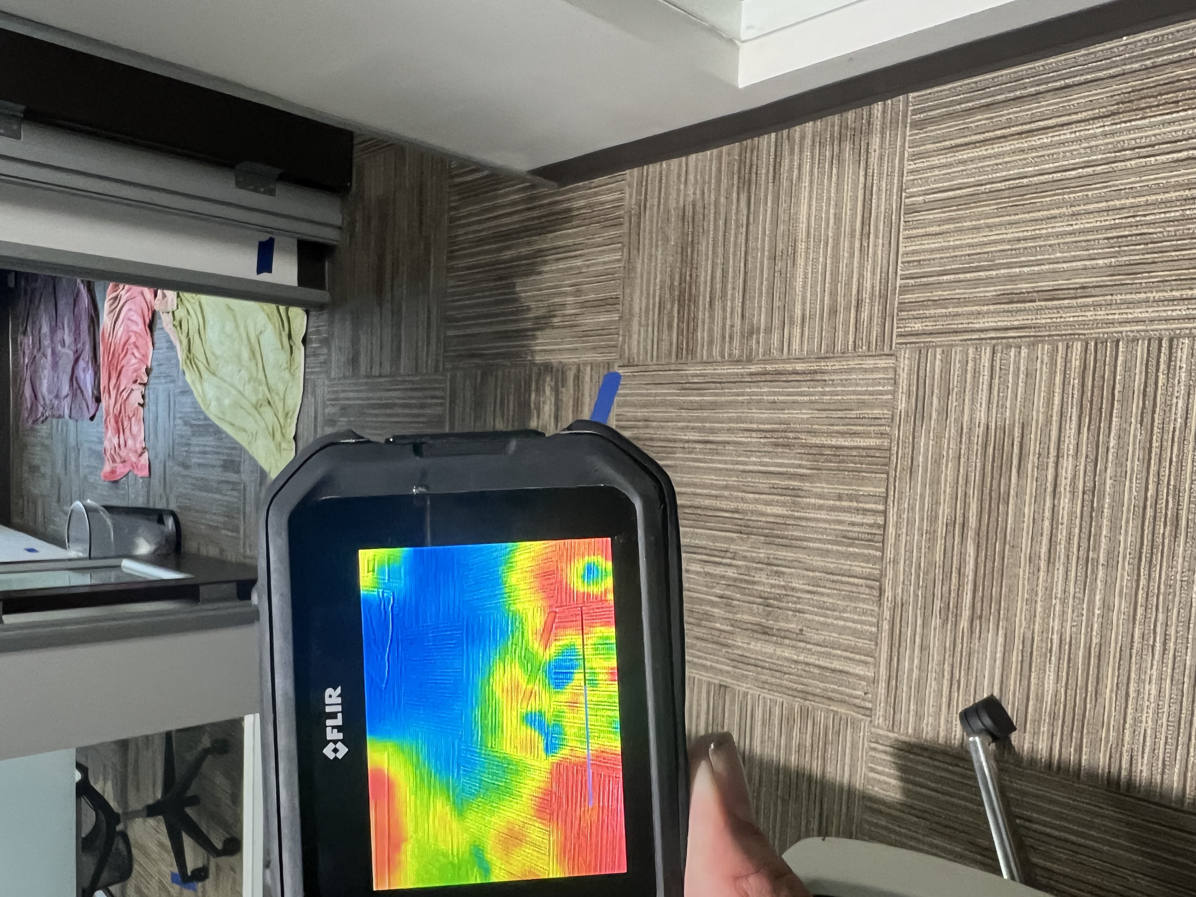 Thermal imaging moisture inspection in a commercial office hallway during water damage restoration